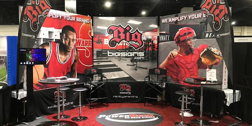 Custom media backdrop by BigSigns for a school sports event, showcasing professional branding for press photos.