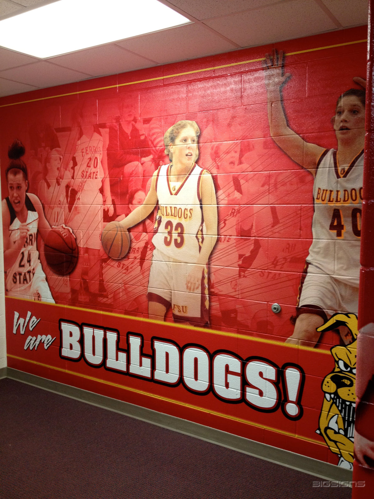 Ferris State basketball wall graphic reading We are Bulldogs! on a block hallway wall
