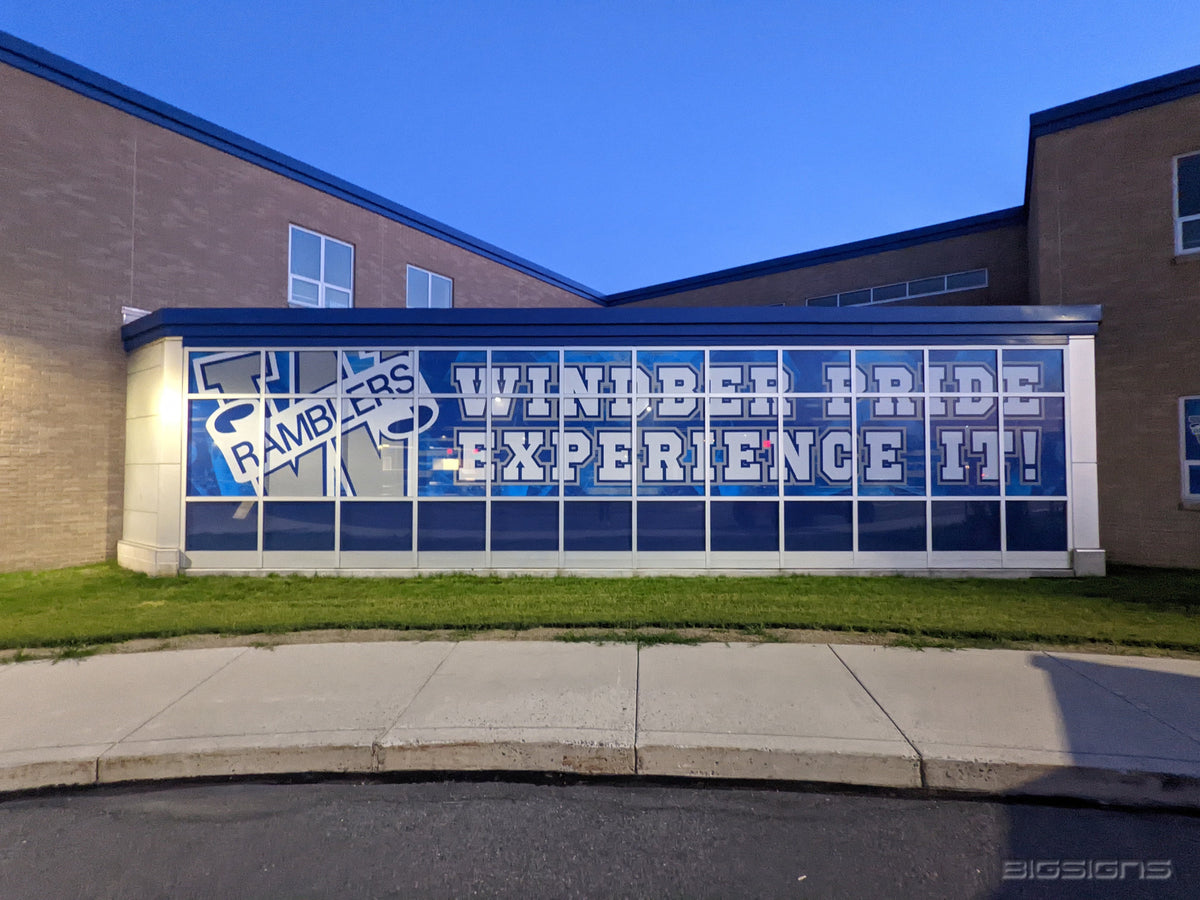 School building glass wall covered in window graphics with a Ramblers W logo and Windber Pride lettering