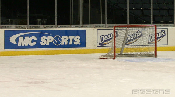 MC Sports and Dean's dasher board ads behind a hockey goal