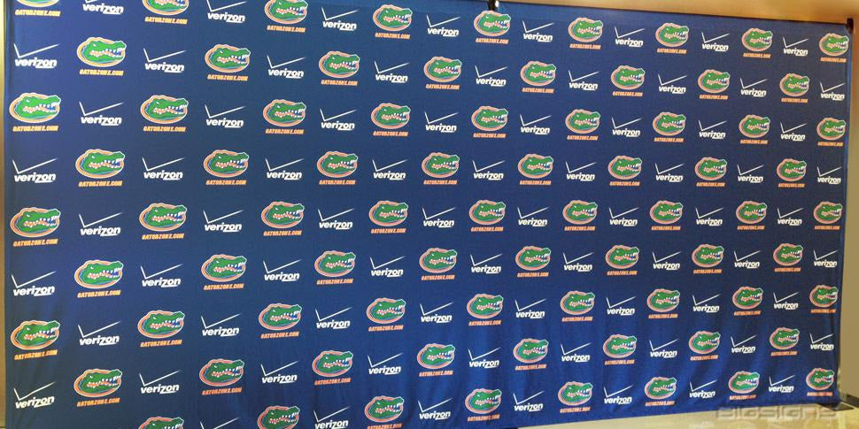 Navy step and repeat backdrop with repeating Florida Gators and sponsor logos