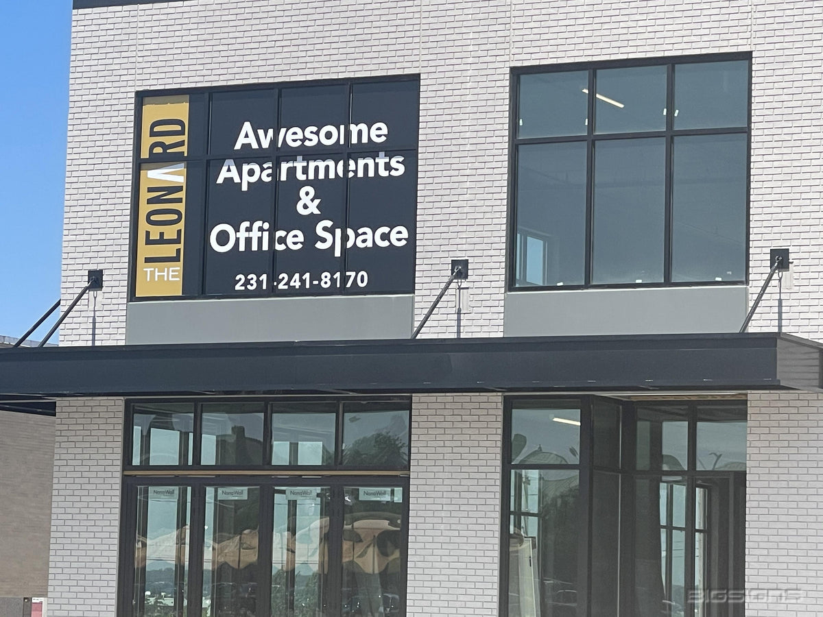 Awesome Apartments & Office Space window graphic with a phone number on a brick building