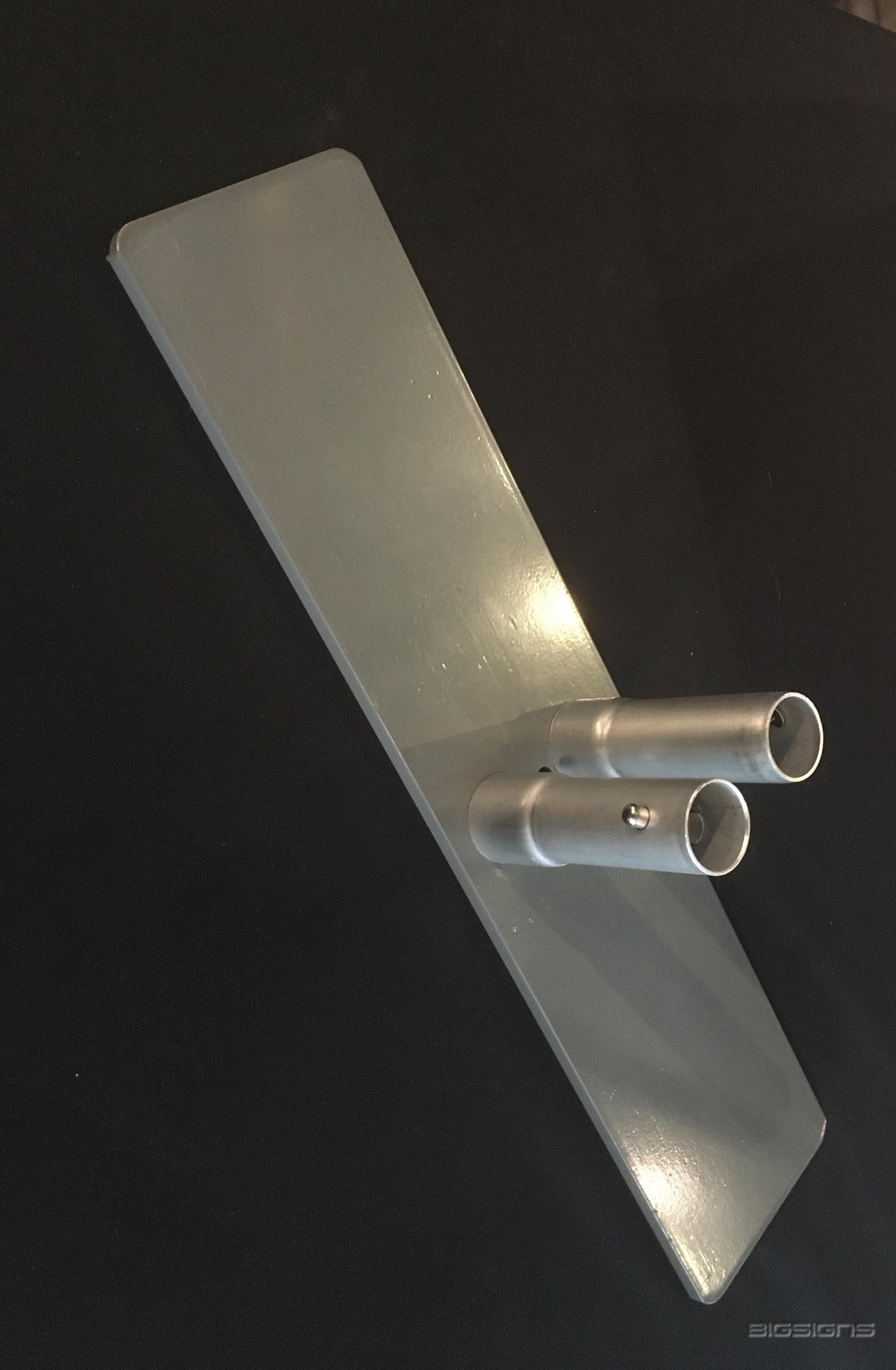 Close-up of a silver base plate with two pole sockets