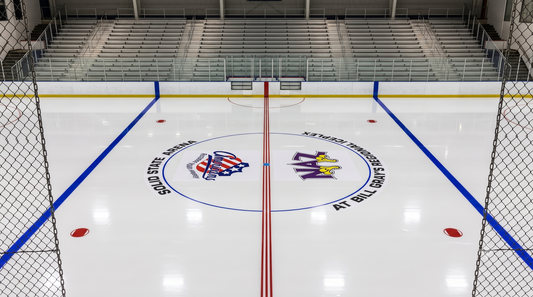 In-ice center circle graphic showing the arena name and two competing team logos printed on a hockey rink surface