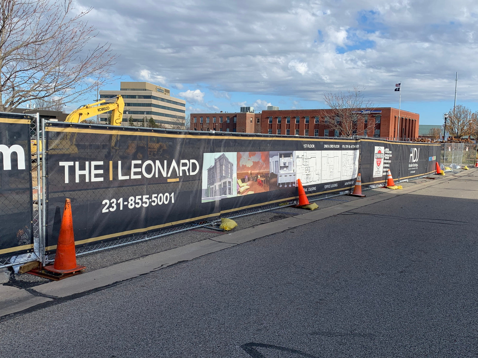 Printed construction fence screen on city job site fencing adding project branding, privacy, safety and dust control.