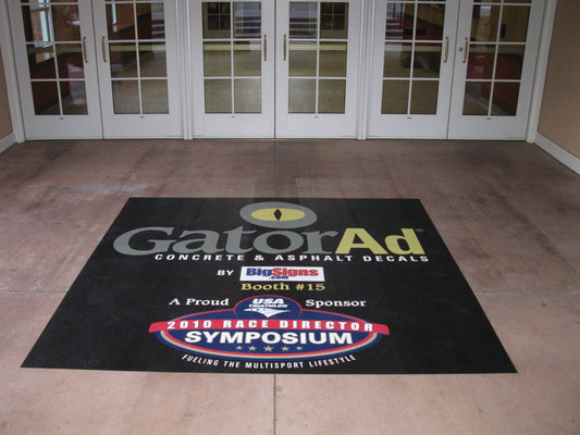 Custom concrete and asphalt floor decal installed at building entrance showing large format graphic on sealed concrete floor