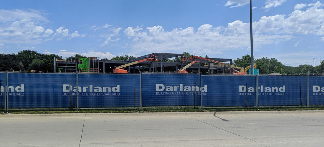 Branded construction windscreen installed on perimeter fencing, improving site visibility, professionalism, and brand value.