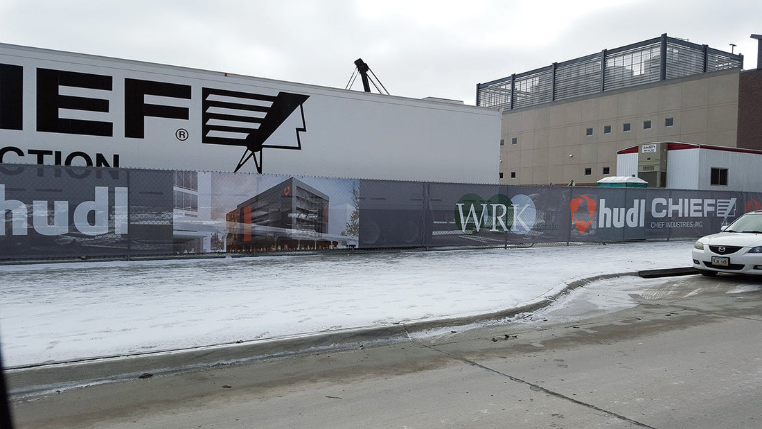 Printed construction fence screen installed on street facing job site, demonstrating branding benefits over privacy windscreens