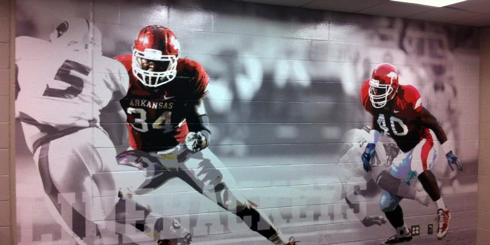 Wall wrap featuring student-athletes in action, designed and installed by BIGSIGNS to energize school hallways and athletic lobbies.