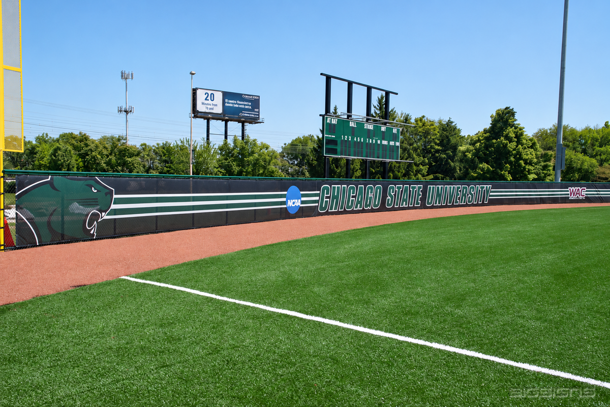 Dark green Chicago State University windscreen along a baseball outfield