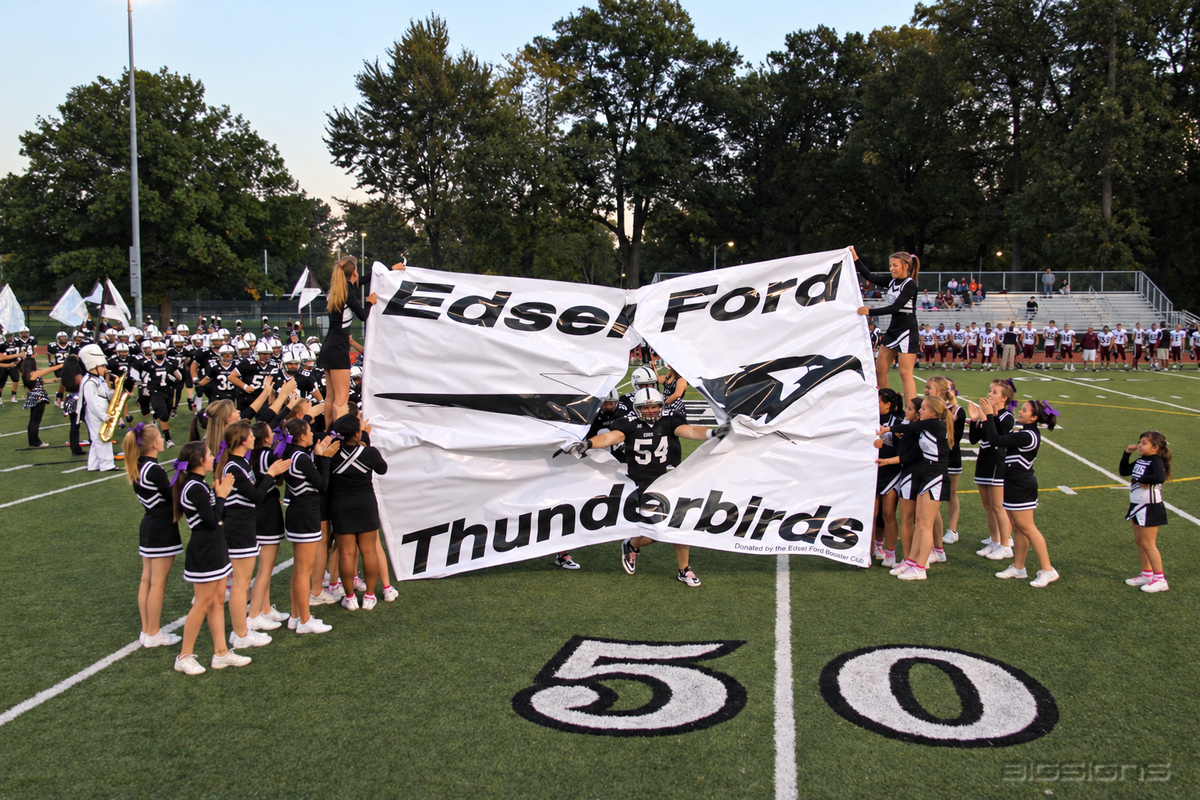 Edsel Ford Thunderbirds breakaway banner held by cheerleaders as a player breaks through