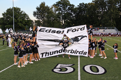 Edsel Ford Thunderbirds breakaway banner held by cheerleaders as a player breaks through