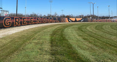 Greenville University athletic mesh fence banner with custom graphics for stadiums, gyms, and sports facilities.
