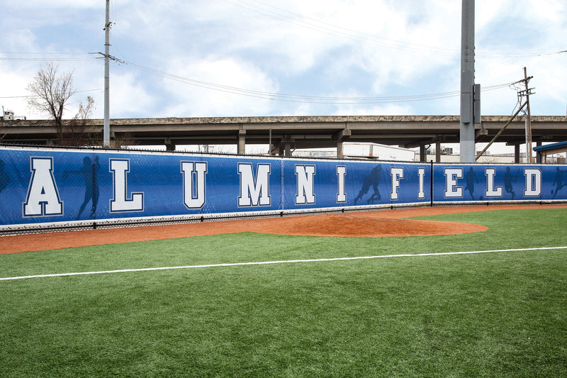 Jesuit-branded Duramesh fence windscreen with baseball graphics — ideal for locker rooms, stadiums, gyms, and sports-facility fences.
