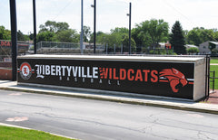 Libertyville Wildcats dugout skin wrap showing custom graphics along the dugout front for baseball facility branding.