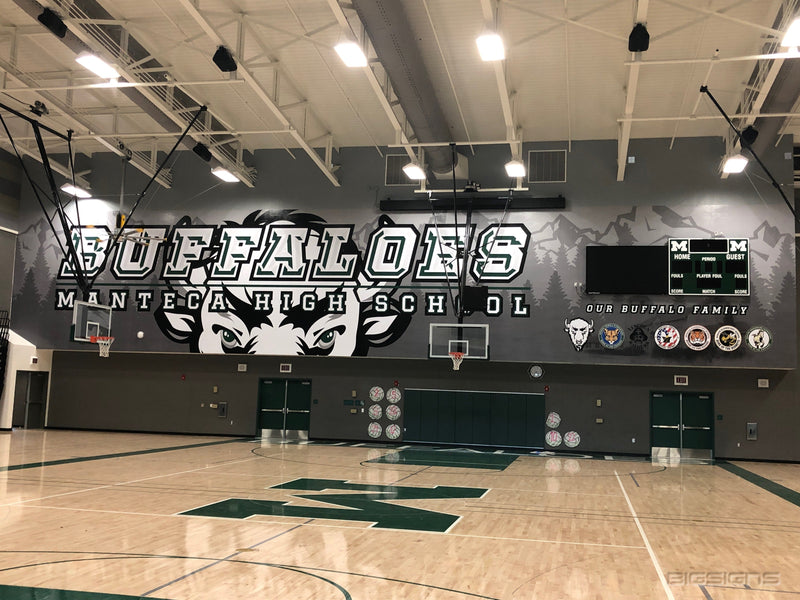 Gym end wall wrapped with Buffaloes and Manteca High School lettering and a large buffalo face