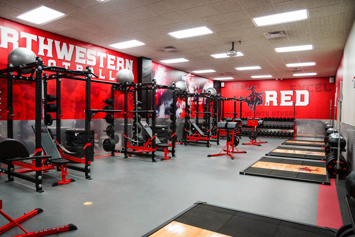 NWOSU football weight room with custom-branded DuraSkin protective wall padding and long rows of professional lifting racks.