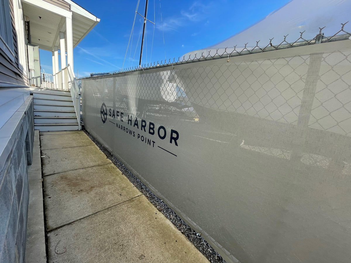 Safe Harbor Narrows Point custom fence windscreen with bold graphics, ideal for athletic fields, sports facilities & events.