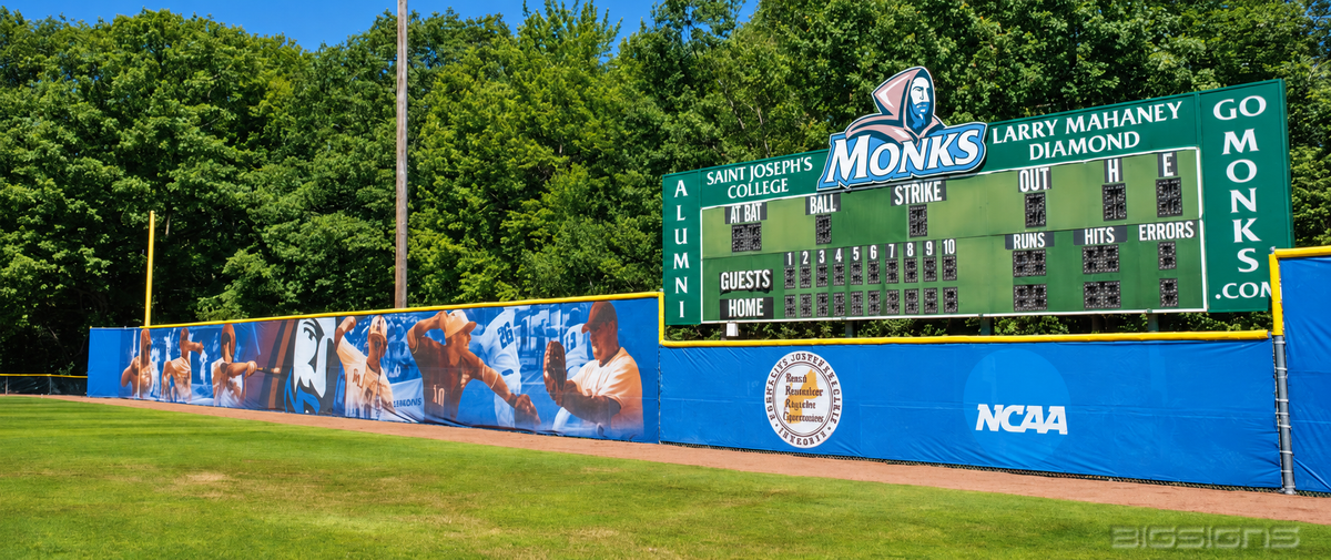 Blue outfield windscreen with player graphics and a Monks scoreboard