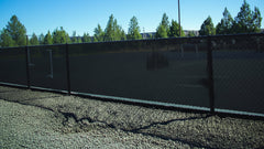 Custom windscreen mockup with bold graphics on fence, ideal for athletic fields, sports facilities, gyms, and outdoor events.