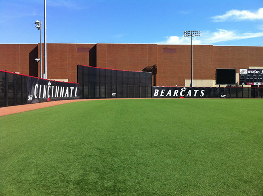 Custom baseball windscreen with bold graphics on stadium fence, perfect for athletic fields, sports facilities and gyms.