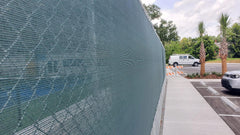Extreme screen windscreen panel installed on fence outdoors, showcasing durable privacy and superior wind control solution.