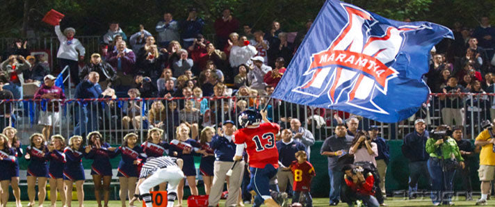 Navy and red M logo RunnerFlag™ carried along the sideline in front of a football crowd