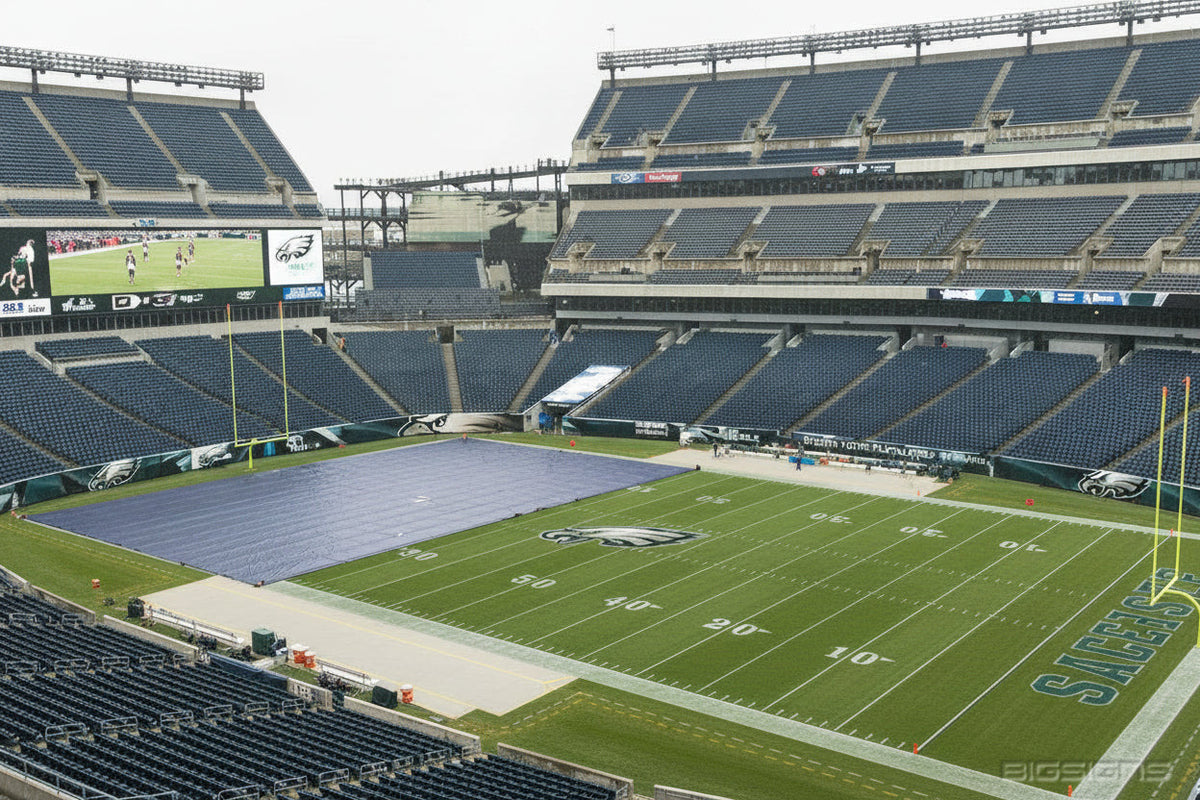 Gray FieldCover™ tarp partly covering a stadium football field beside the Eagles end zone