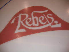 Rebels ice logo in red and white applied beneath the rink surface for custom center ice branding in a hockey arena.