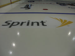 Sprint sponsor logo installed on hockey rink ice beside the blue line for clean branded advertising and arena visibility.