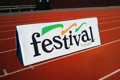 Outdoor field with windscreen running along fence, ideal visual for crowd control, sports venues, and perimeter privacy.
