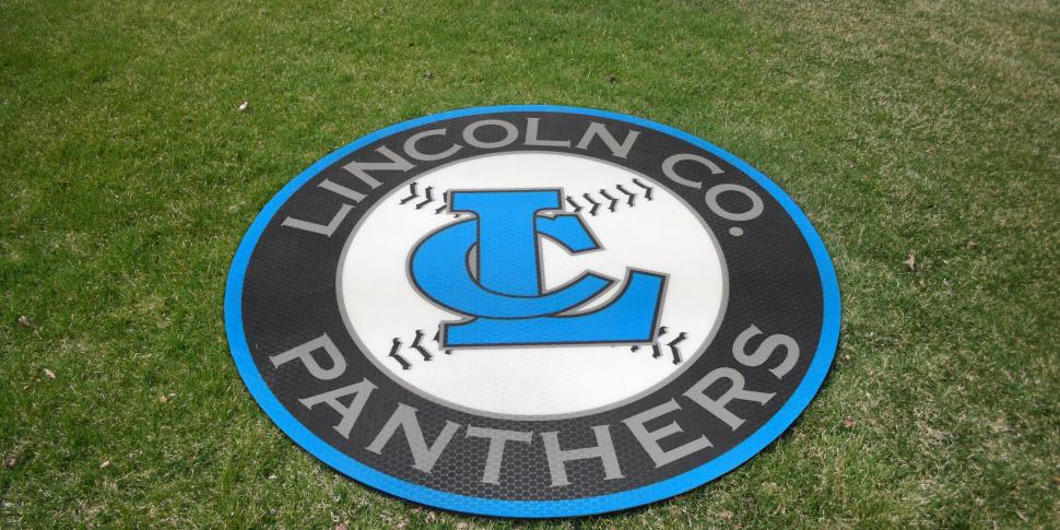 Blue and gray Lincoln Co. Panthers LC logo on-deck circle on grass
