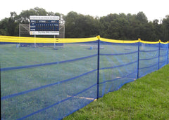 Linked metal fence panels set up on lawn, showing rugged portable fencing used for construction sites or public gathering areas.