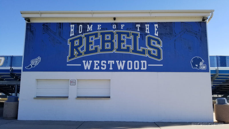 Stadium building wrapped with graphics reading Home of the Rebels, Westwood