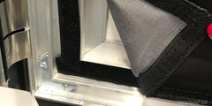 Close-up of the frame corner showing the hook-and-loop strip that holds the graphic in place