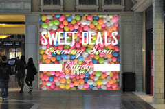 Retail barricade wrapped in custom wall wrap graphics for branding, privacy, and event signage around construction areas zone