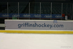 Ice rink window graphics with sponsor branding, ideal for window graphics and event signs in sports arena environments