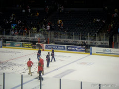 Rink glass window wraps displaying bold sponsor ads, perfect for window wraps and event banners in athletic venues